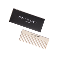 Percy & Reed cream-colored wide-tooth comb with black box packaging, featuring brand logo.